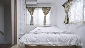 A bedroom with a bed, curtains, and a window. - 3BR - Shinjuku area, 5mins from station (Tokyo)