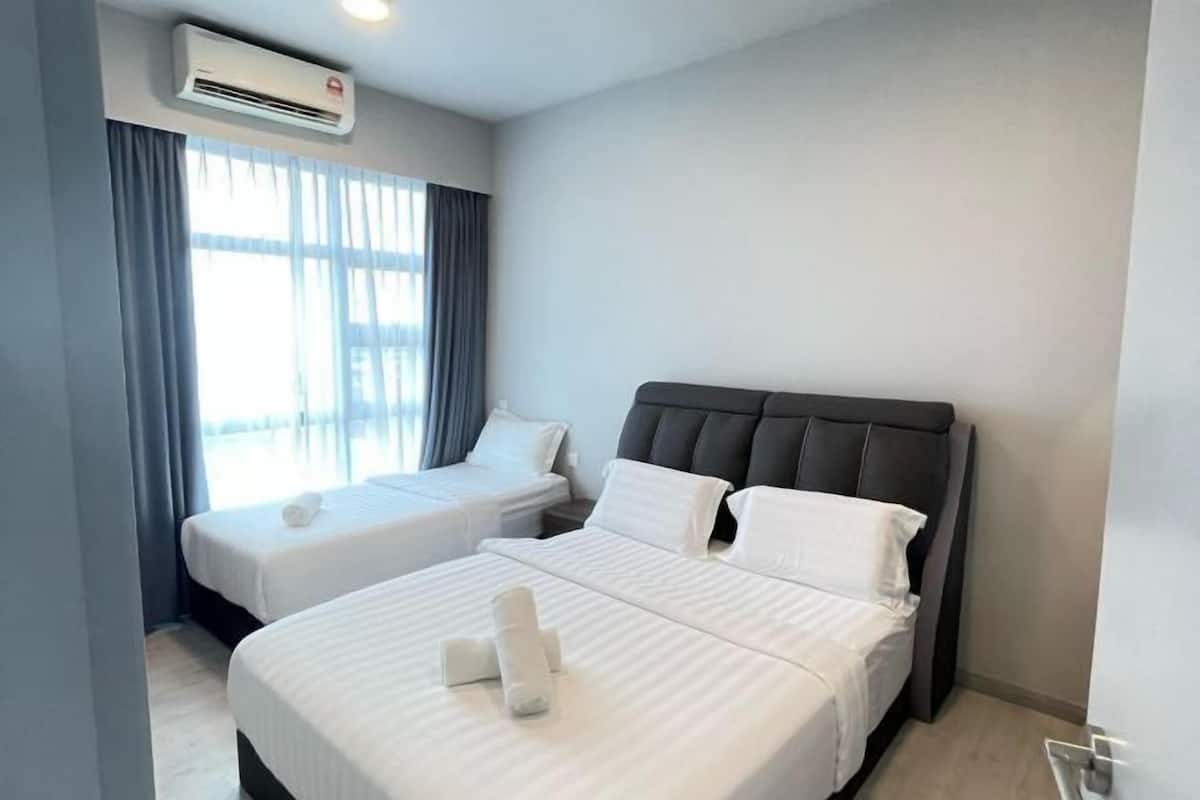A hotel room with two beds, a large window with curtains, an air conditioning unit, and a modern design.