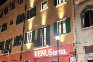 A hotel with a red facade and green shutters, named 'VENUS HOTEL.' - VENUS HOTEL PHU QUOC (Phu Quoc Island)