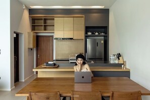 A modern kitchen with a central island, a dining table, and chairs. - Casa Harmony H3 Private Pool 3BR Near Nimman (Chiang Mai)