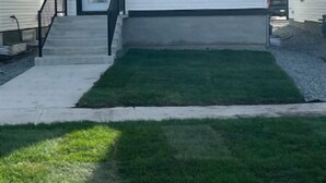 A two-story house with a front porch, a small front yard, and a garage. - Cutee Home in Prairie Pointe (Winnipeg)