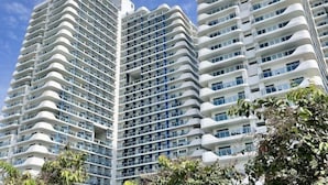 A high-rise building with multiple balconies and a modern architectural design. - 2 BR Penthouse w/ Wide Balcony and 7ft Billiards (San Fernando)