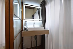 A bathroom with a mirror, sink, and shower curtain. - Bunka 1 chome (Tokyo)