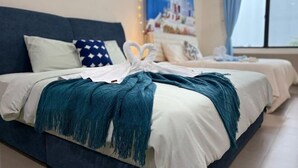 Een hotelkamer met een bed, een blauw hoofdbord en uitzicht op een gebouw door het raam.