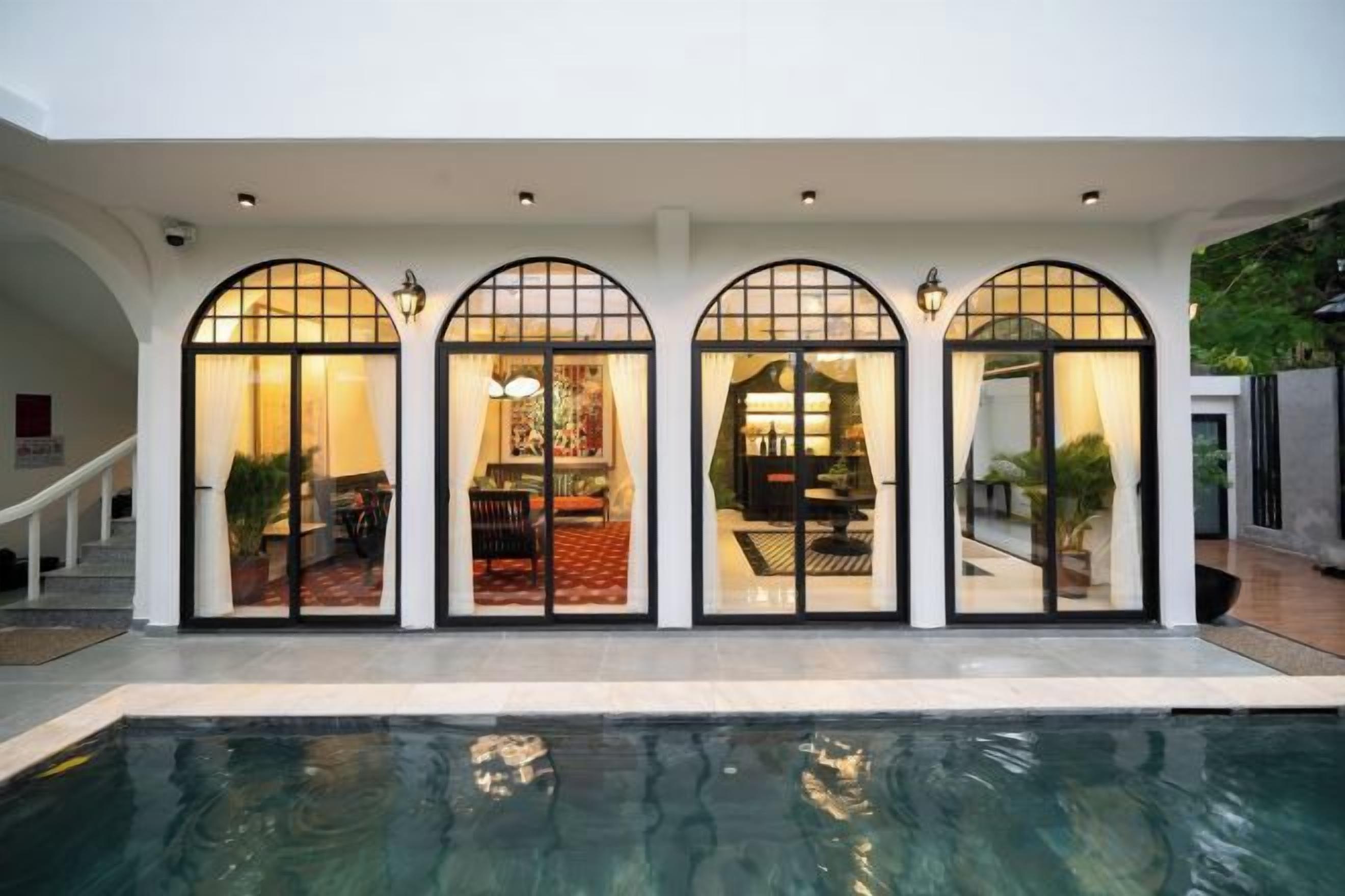A poolside area with a covered seating area and a pool.