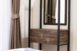 A wooden bedside table with a mirror, a curtain, and a wall-mounted shelf. - Summer Sea Villa Khanom (Khanom)