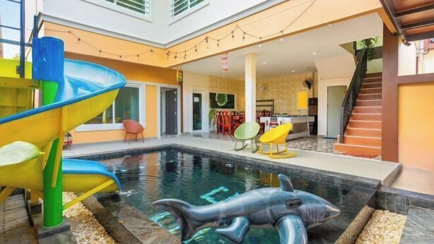 A swimming pool with a shark decoration, a slide, and a staircase. - 99 Pool Villa (Pattaya)