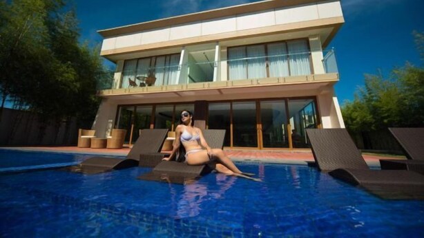 A modern two-story building with a swimming pool. - The First Islatel (Alaminos)