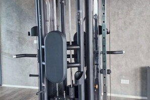 A gym with a pull-up bar, a bench, and a wall-mounted rack. - H&W Sunway Onsen Suite S-13-05 near Lost World of Tambun Ipoh (Ulu Kinta)