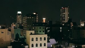 A nighttime cityscape with illuminated buildings and a prominent white building with arched windows in the foreground. - 5 mins to Motomachi Station/harbour land park B64-1 (Kobe)