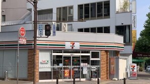 A 7-Eleven convenience store with a clear storefront, a visible entrance, and a parking area in front. - 5 mins to Motomachi Station/harbour land park B64-1 (Kobe)