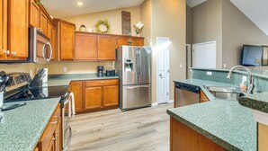 A modern kitchen with wooden cabinets, stainless steel appliances, and a green granite countertop. - Bar, Pool Table & Yard! Spacious Union Home (Union)