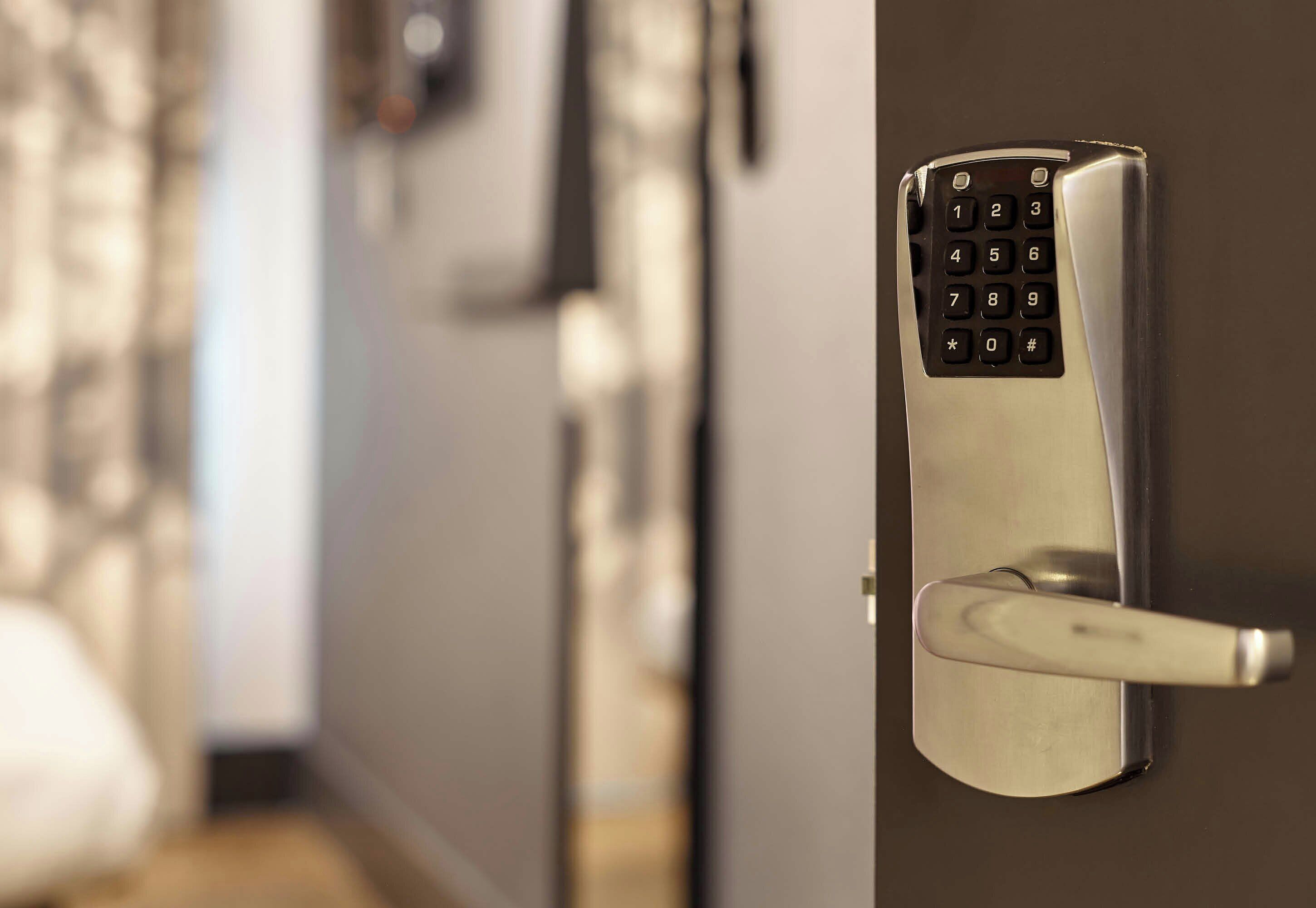 A modern door with a numeric keypad lock.