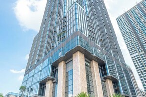 A high-rise building with a modern glass facade and a prominent corner entrance. - THE LANDMARK 81 LUXURY ART CONDOTEL (Ho Chi Minh City)