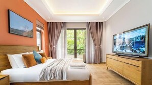 A modern hotel room with a large bed, a TV, and a wooden cabinet. - KN3 Holiday Villa (Ho Chi Minh City)