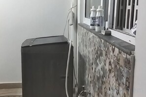 A bathroom with a black heater, a towel rack, and a window with a view. - RU YI HOTEL(SMC-PRIVATE) LIMITED (Islamabad)