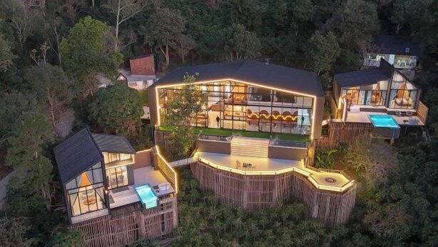 A modern, multi-level house with large glass windows, a swimming pool, and a wooden deck. - Misty Valley Doichang (Mae Suai)