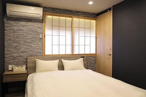 A bedroom with a bed, nightstand, and a window with a view. - Kin・ Tengachaya8-14 (Osaka)