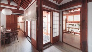 A traditional Japanese interior with wooden beams, sliding doors, and a dining area with a table and chairs. - [NuileStay] Seoul Gorgeous Hanok - Gyeongbokgung Station(5min) (Seoul)