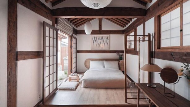 A traditional Japanese-style bedroom with a wooden ceiling, a bed with white bedding, a bedside table with a lamp, and a window with wooden frames. - [NuileStay] Seoul Gorgeous Hanok - Gyeongbokgung Station(5min) (Seoul)