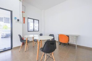 A room with a dining table, chairs, a small kitchen area, and a window. - 28 RESIDENCE-R13 (Sepang)