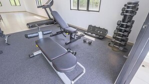 A gym with a bench press, dumbbells, and a treadmill. - 28 RESIDENCE-R13 (Sepang)