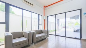 A modern waiting area with two sofas, large windows, and a tiled floor. - 28 RESIDENCE-R13 (Sepang)