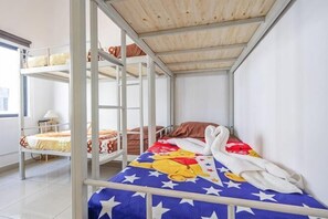 A bunk bed room with a wooden ceiling, a window, and a bed with a star-patterned blanket. - 28 RESIDENCE-R13 (Sepang)