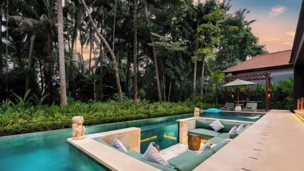 A pool area with lounge seating and a pergola. - Villa Surya by BaliSuperHost (Bali)