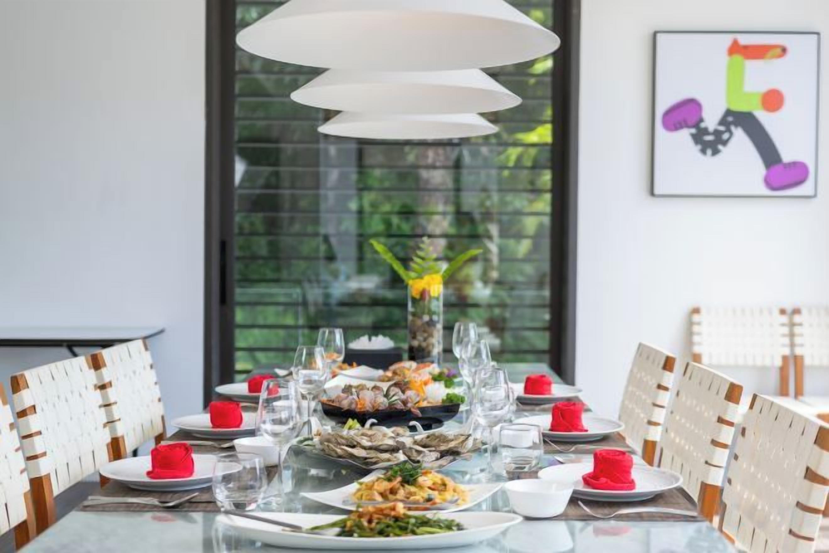 A dining table set with plates, glasses, and a centerpiece.