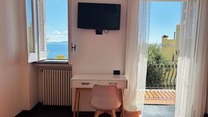 Una stanza con scrivania, sedia e televisore a parete.