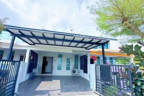 A covered outdoor area with a metal roof, a paved entrance, and a gated entrance. - Bangi Avenue Charming 4BR Blissful Double Storey (Kajang)