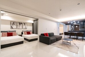 A modern hotel room with two beds, a sofa, a dining area, and a kitchen. - CREAL premier Akasaka (Minato-ku)