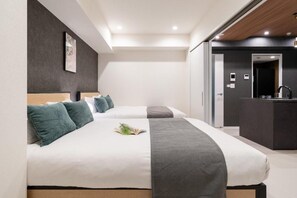 A hotel room with two beds, a small kitchenette, and a bathroom visible through an open door. - CREAL premier Akasaka (Minato-ku)