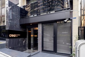 A modern building with a prominent 'creal premier' sign, large glass doors, and a metal fence. - CREAL premier Akasaka (Minato-ku)