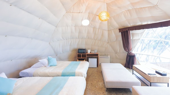 A tent-style room with two beds, a small table, a microwave, and a refrigerator. - Livemax Seto Ohashi Beach Resort (Kurashiki)