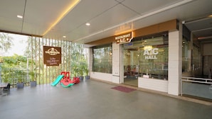 A spacious indoor area with a children's play area, a restaurant named 'A.C. Hall', and a sign for 'Sauburg Sauburg'. - Hotel Saubhagya Ahmedabad (Ahmedabad)