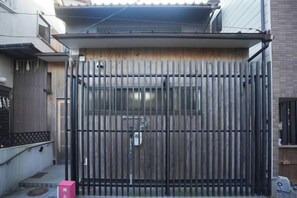 A gated entrance with a metal gate, a small window, and a utility box. - KIRAKU･SHIMIZU (Kyoto)