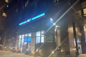 A building with a prominent sign, large windows, and a visible entrance. - SUNNY HOUSE (Seoul)