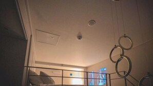 A bunk bed room with a ceiling fan, a visible light fixture, and a window with a view. - SUNNY HOUSE (Seoul)