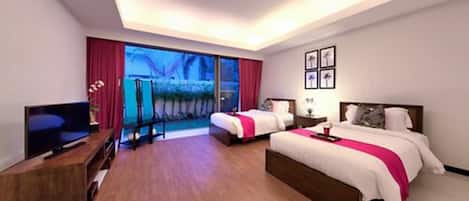 A hotel room with two beds, a TV, and a large window with a view.