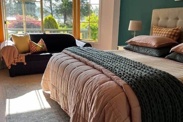 Sun streaming into the bedroom and a beautifully dressed kingsize bed with Belgium linen