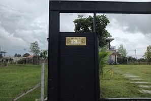 A gated entrance with a sign displaying the number 221. - U-Kham Home View At Sirindhorn (Sirindhorn)