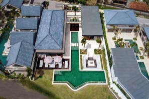 A resort with multiple buildings, a swimming pool, and a well-maintained lawn. - Villa Sweet Paradise by BaliSuperHost (Bali)