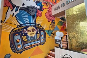 A Hard Rock Cafe with a vibrant mural, a radio, and a staircase. - Ipoh Homestay Vacation 12 Pax 4 Bedroom for Delicious Food (Ipoh)