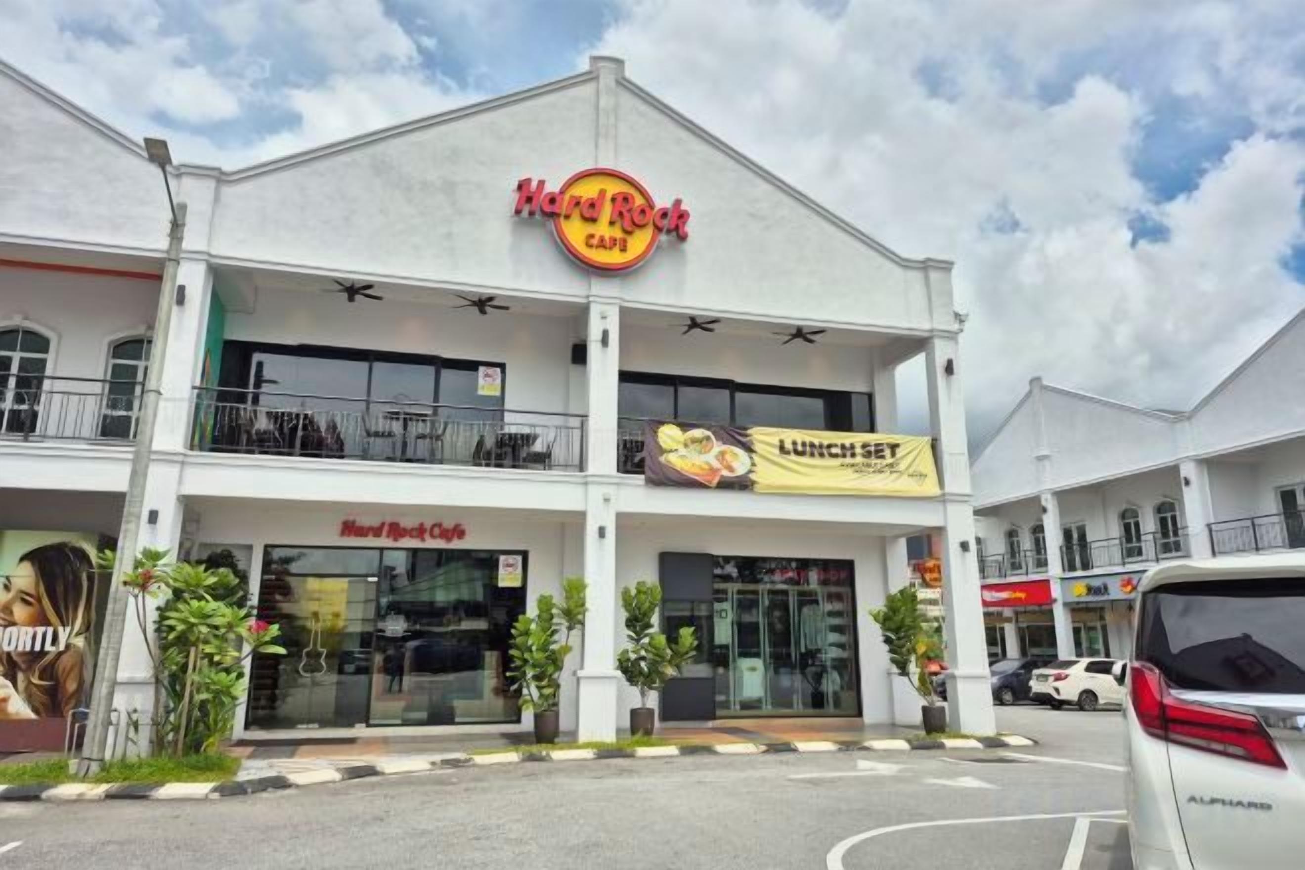 A Hard Rock Cafe with a prominent sign, a second-story balcony, and a 'Lunch Set' banner.