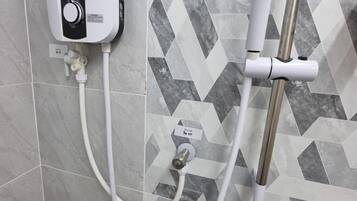 A shower control panel with a hose and a handheld showerhead.