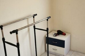 A room with a metal frame structure, a small white cabinet with drawers, and a pair of shoes on top. - Ipoh Homestay Vacation 12 Pax 4 Bedroom for Delicious Food (Ipoh)