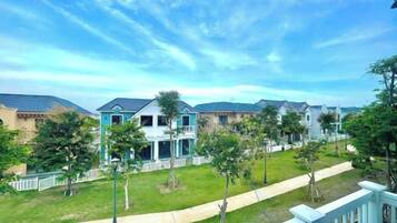A residential area with houses, a pathway, and a clear sky.