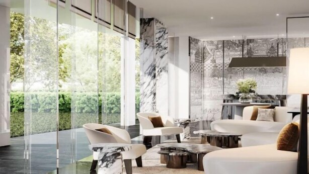A modern living room with a large window, marble accents, and a stone wall. - La Clef Bangkok by The Crest Collection (Bangkok)